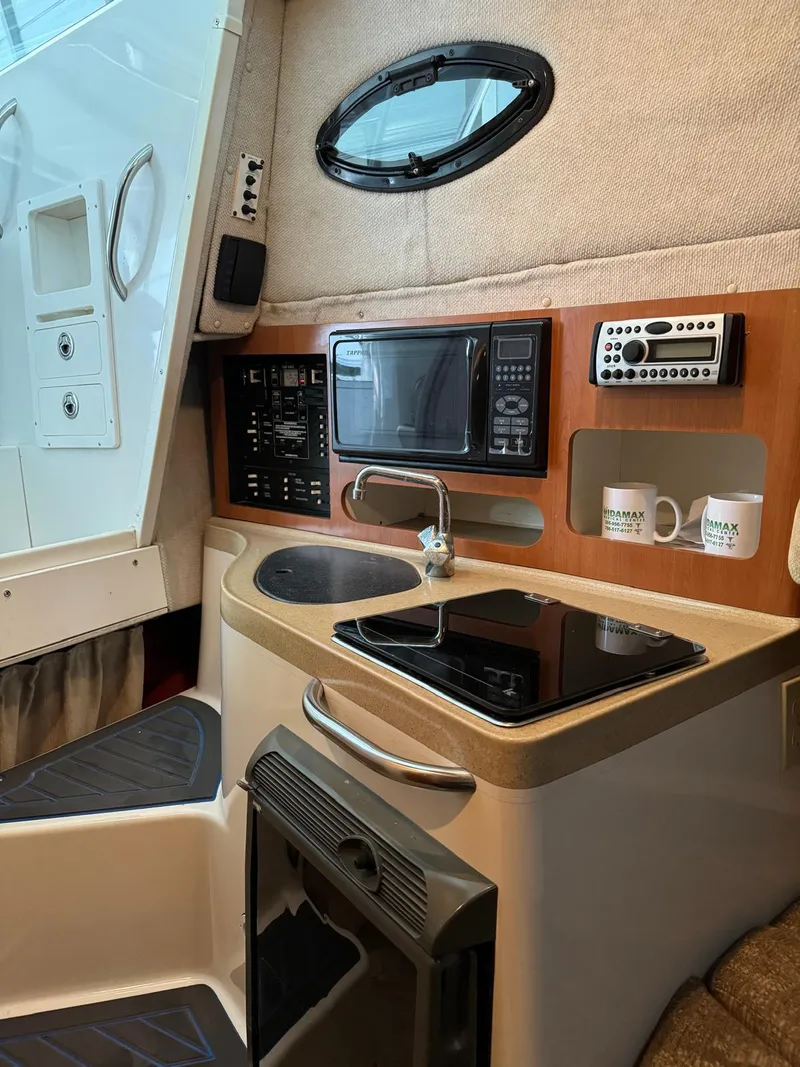 Slide: The Image of 2005 Seaswirl Striper 2901 Walkaround O/B cabin with kitchenette and modern amenities. - 8