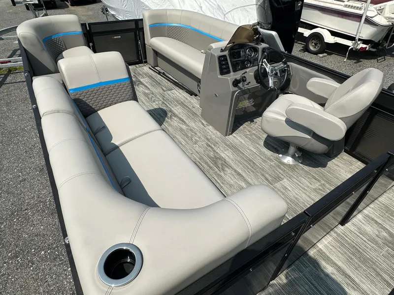 Slide: The Image of 2024 Qwest E 816 RLS LT pontoon boat interior with plush seating and modern helm. - 2