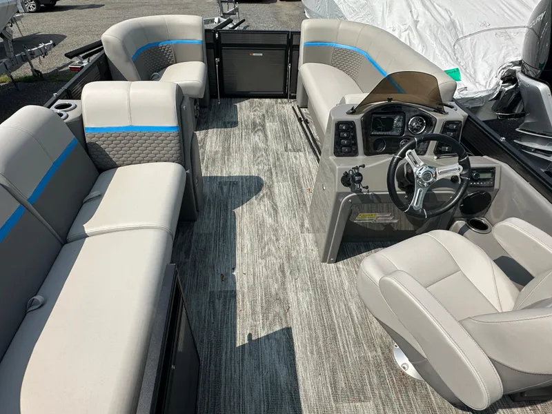 Slide: The Image of 2024 Qwest E 816 RLS LT pontoon boat interior with plush seating and modern dashboard. - 3