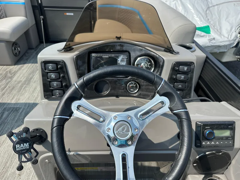 Slide: The Image of 2024 Qwest E 816 RLS LT boat dashboard with steering wheel and controls. - 4