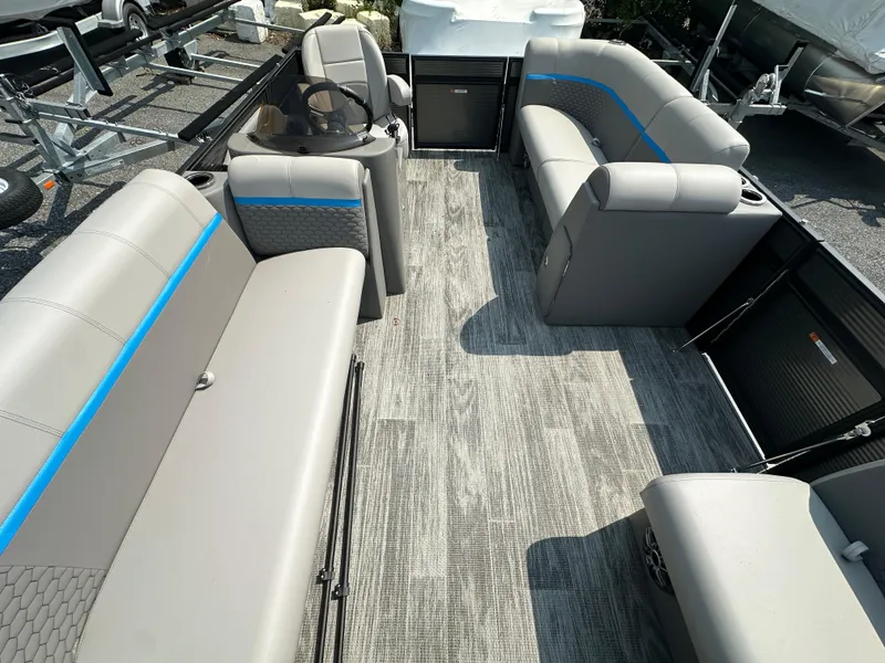 Slide: The Image of 2024 Qwest E 816 RLS LT pontoon boat interior with gray seating and blue accents. - 7