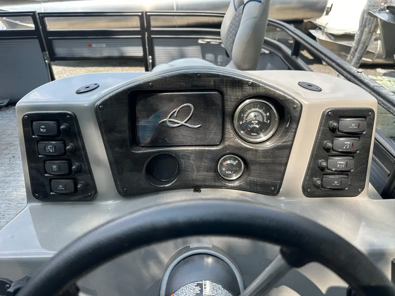 Slide: The Image of 2024 Qwest 814 CTR Fish L boat dashboard with controls and steering wheel. - 2