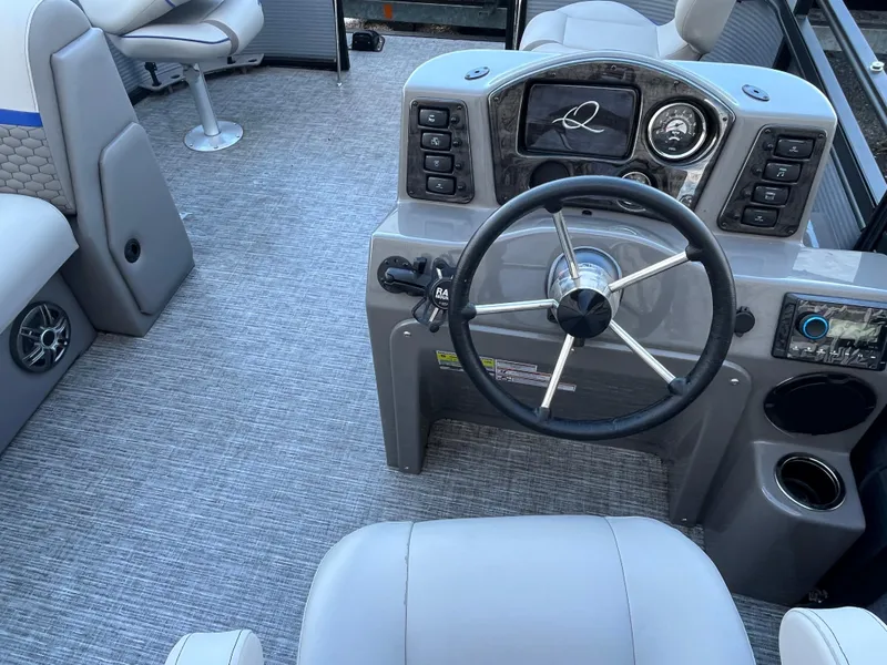 Slide: The Image of 2024 Qwest 814 CTR Fish L boat dashboard with steering wheel and controls. - 6