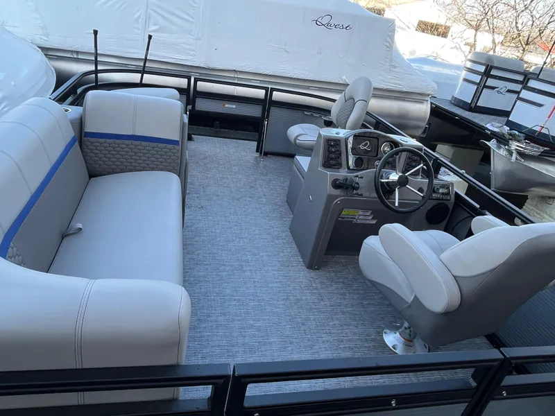 Slide: The Image of 2024 Qwest 814 CTR Fish L pontoon boat interior with seating and steering console. - 8