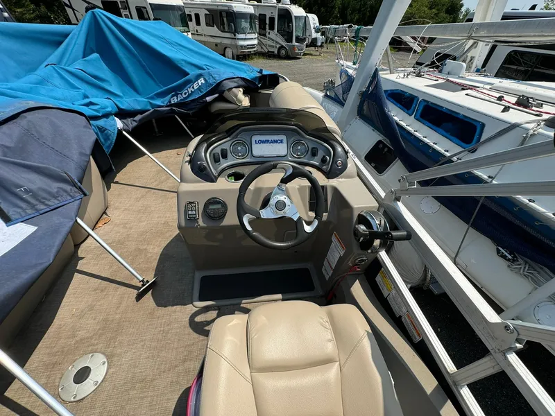 Slide: The Image of 2020 Tracker FISHIN 22 BARGE DLX boat interior with steering wheel and control panel. - 8
