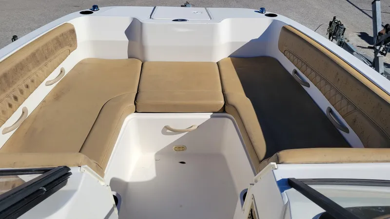 Slide: The Image of 2020 Bayliner DX2200 PROJECT boat interior with beige seating and storage compartments. - 10