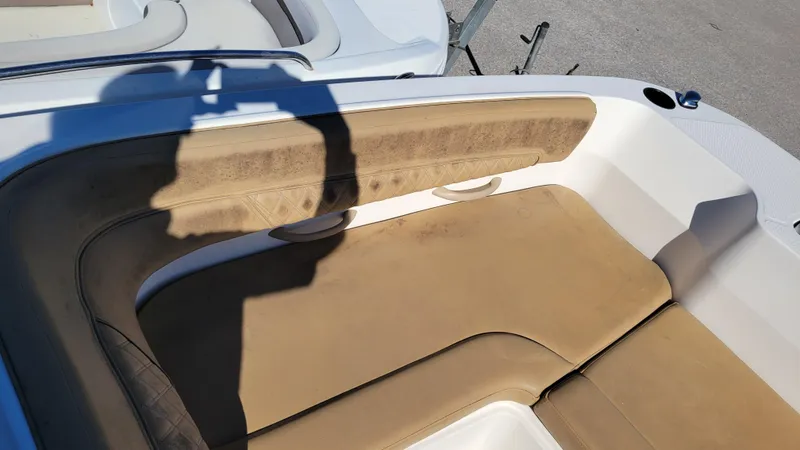 Slide: The Image of Bayliner DX2200 PROJECT 2020 boat interior with tan seating and shadow. - 13