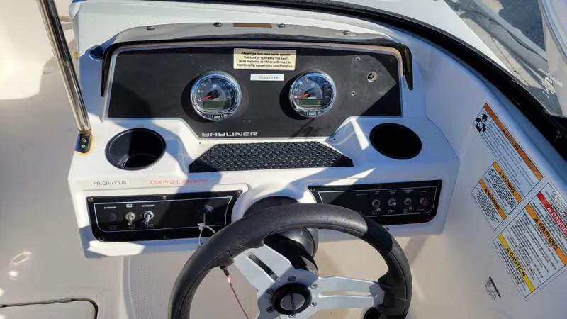 Slide: The Image of Bayliner DX2200 PROJECT 2020 boat dashboard with steering wheel and gauges. - 17