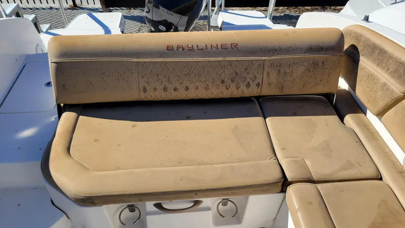 Slide: The Image of Bayliner DX2200 PROJECT 2020 boat with tan seating, slightly worn condition. - 19