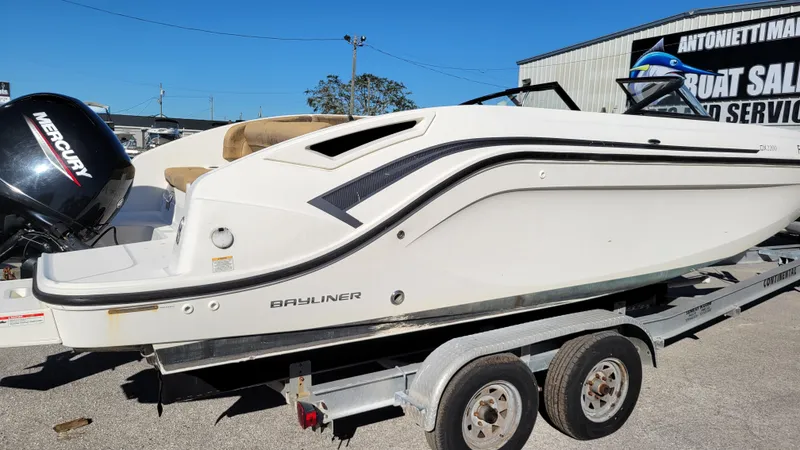 Slide: The Image of 2020 Bayliner DX2200 PROJECT boat on trailer, side view, outdoors. - 2