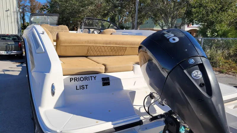 Slide: The Image of Bayliner DX2200 PROJECT 2020 boat with outboard motor and tan seating. - 4