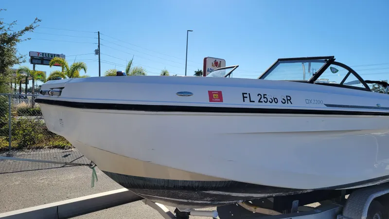 Slide: The Image of 2020 Bayliner DX2200 PROJECT boat on trailer, parked outdoors. - 7