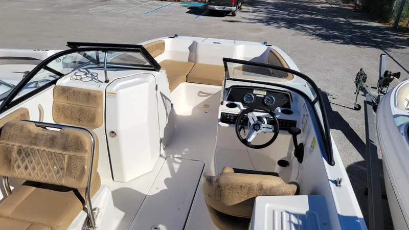 Slide: The Image of 2020 Bayliner DX2200 PROJECT boat interior with beige seating and steering console. - 9