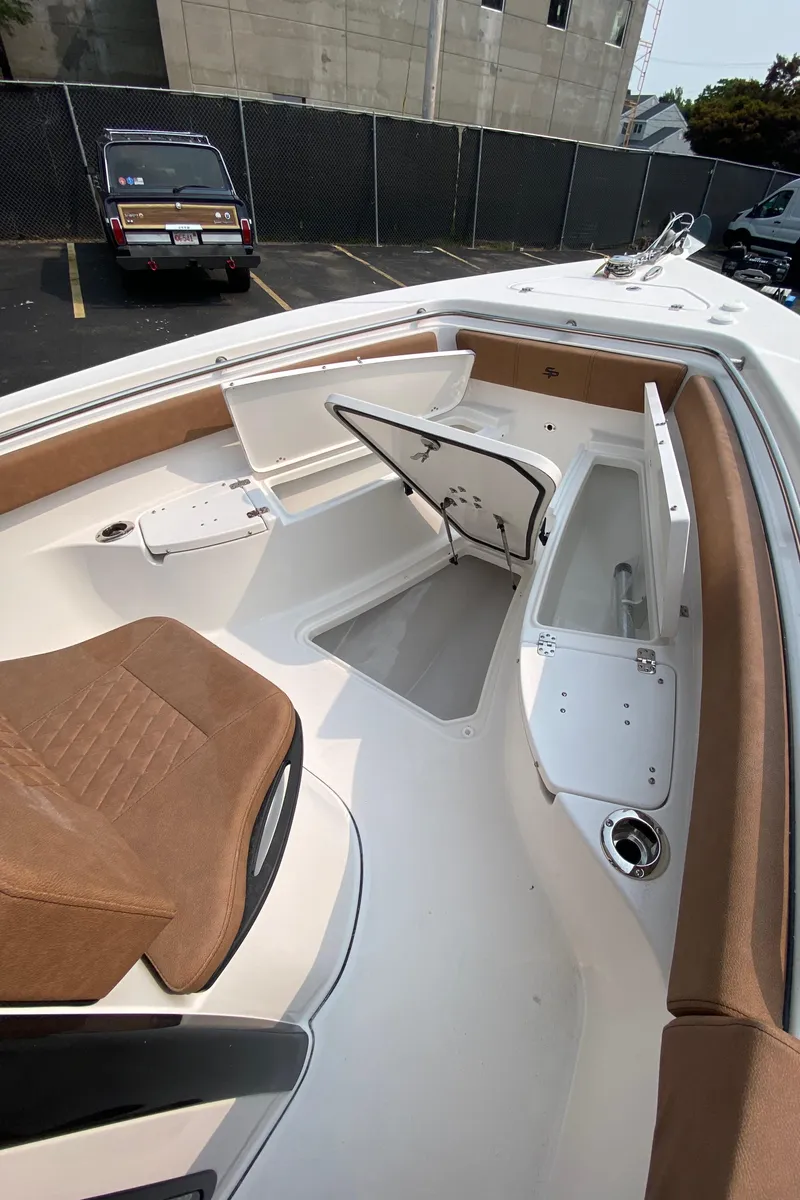 Slide: The Image of 2024 Sea Pro 242 Center Console boat interior with seating and storage compartments. - 12