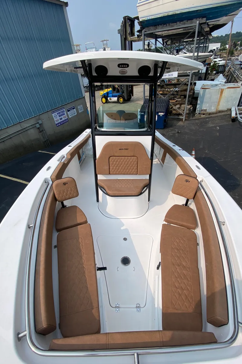 Slide: The Image of 2024 Sea Pro 242 Center Console boat with tan seating and sleek design. - 14