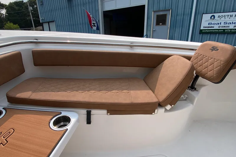 Slide: The Image of 2024 Sea Pro 242 Center Console boat with tan cushioned seating and cup holders. - 15