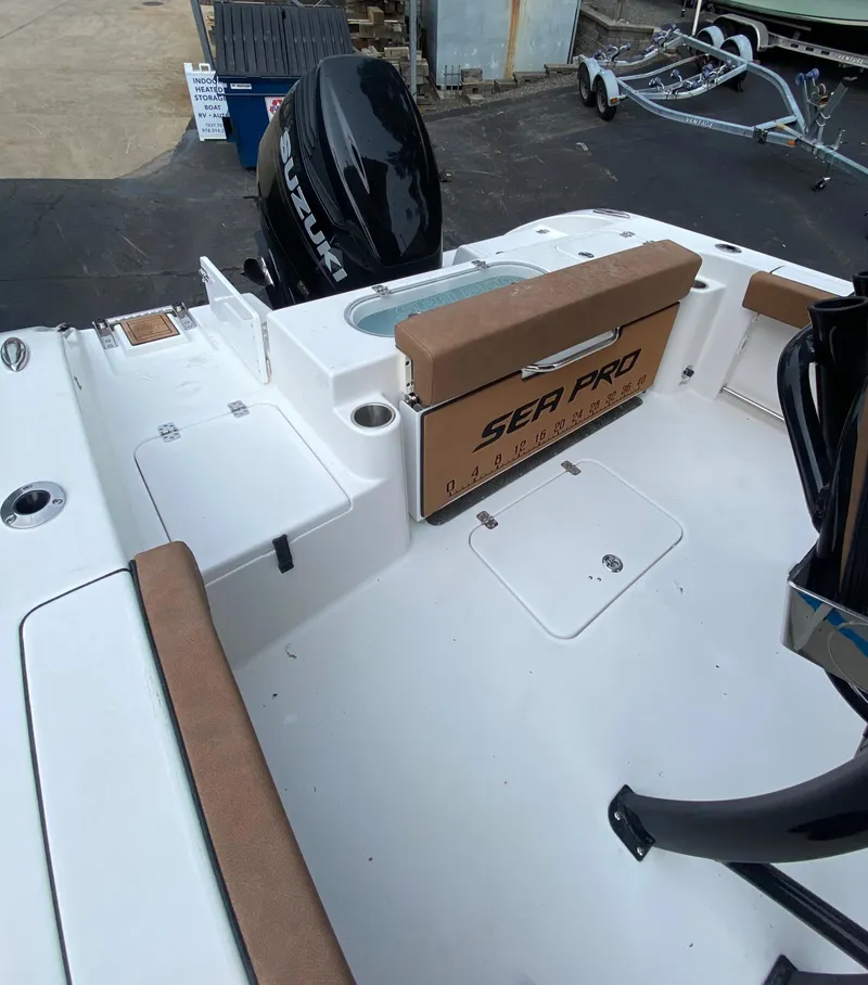 Slide: The Image of 2024 Sea Pro 242 Center Console boat interior with seating and motor. - 5