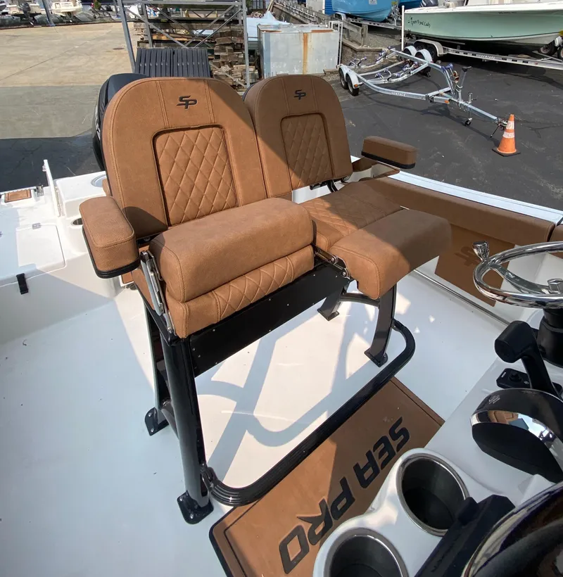 Slide: The Image of 2024 Sea Pro 242 Center Console boat with brown cushioned seating. - 8