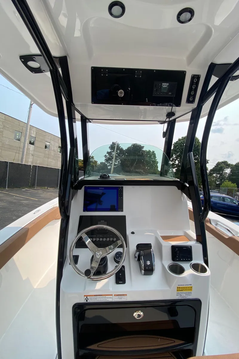 Slide: The Image of 2024 Sea Pro 242 Center Console boat interior with steering wheel and control panel. - 9