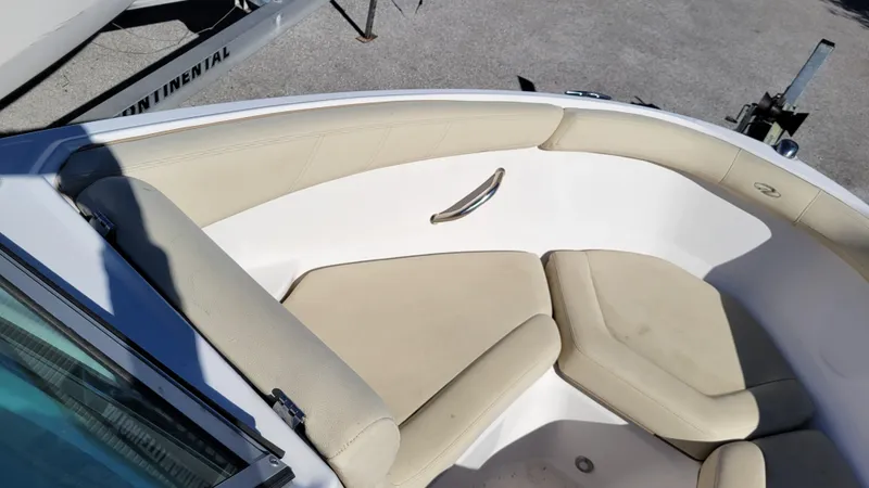 Slide: The Image of 2020 Regal 21 OBX PROJECT boat interior with beige seating and stainless steel handle. - 14