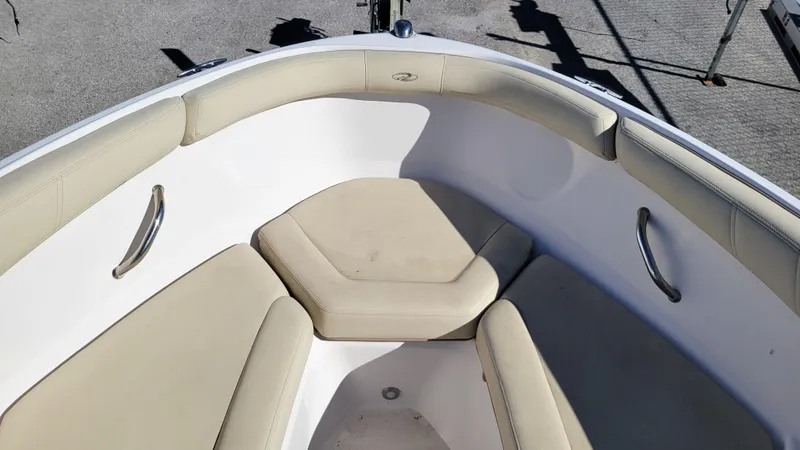 Slide: The Image of 2020 Regal 21 OBX PROJECT boat interior with beige seating and stainless steel handles. - 15