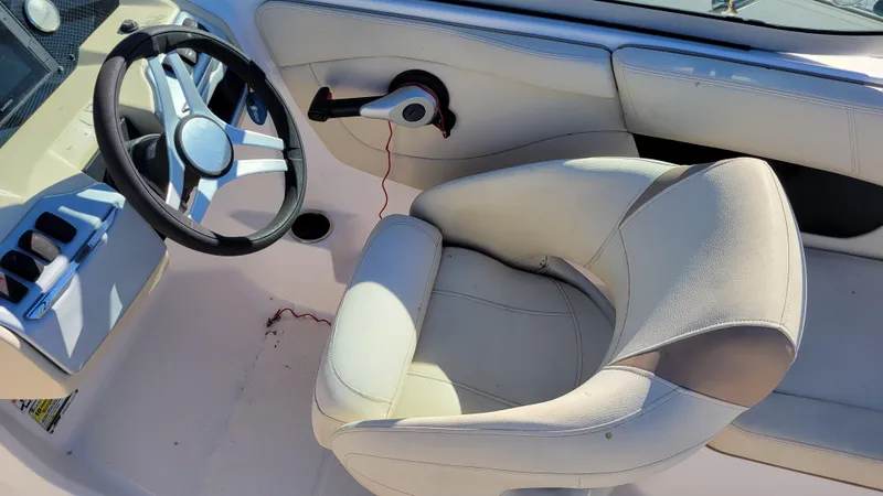 Slide: The Image of 2020 Regal 21 OBX PROJECT boat interior with steering wheel and cushioned seat. - 17
