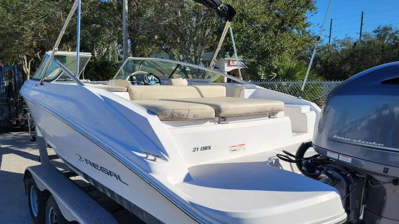 Slide: The Image of 2020 Regal 21 OBX PROJECT boat with outboard motor, parked on a trailer. - 5
