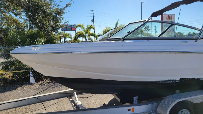 Slide: The Image of 2020 Regal 21 OBX PROJECT boat on trailer, parked outdoors. - 7