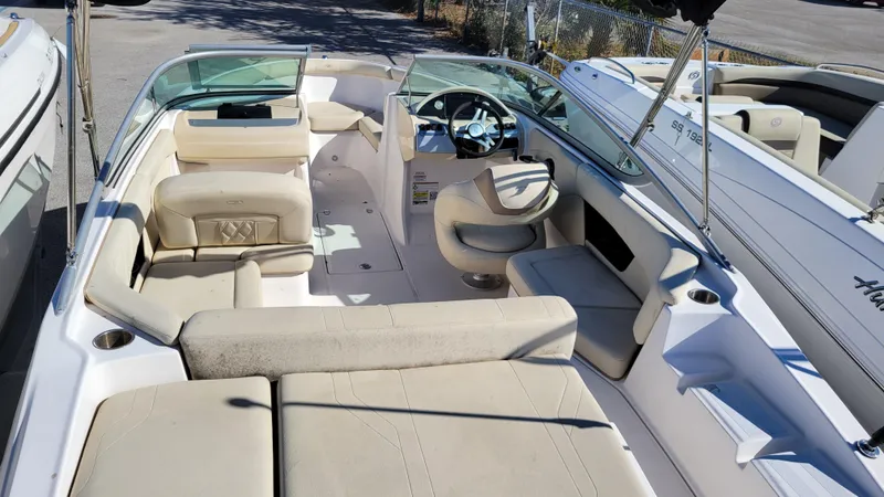 Slide: The Image of 2020 Regal 21 OBX PROJECT boat interior with beige seating and steering wheel. - 9