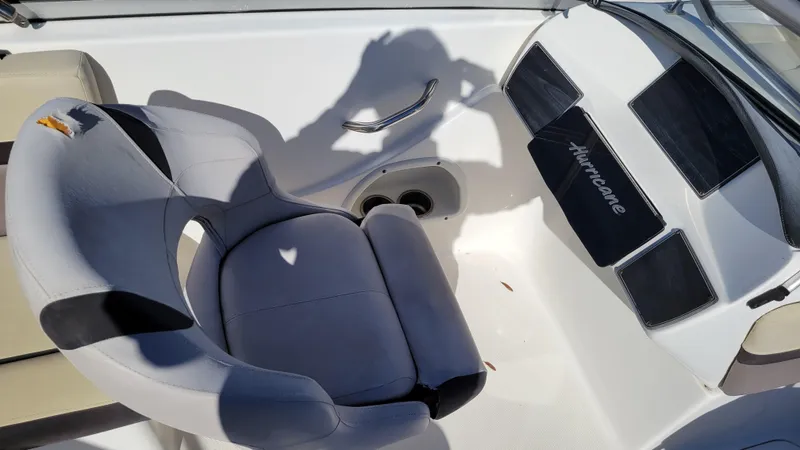 Slide: The Image of 2019 Hurricane SUNDECK 217 PROJECT boat interior with gray seating and steering area. - 12
