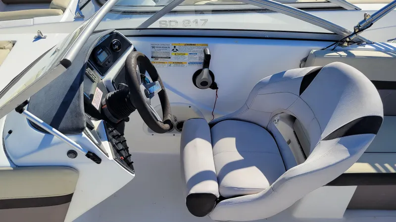 Slide: The Image of 2019 Hurricane SUNDECK 217 PROJECT boat cockpit with steering wheel and cushioned seat. - 16
