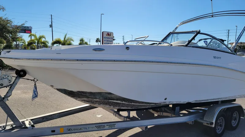 Slide: The Image of 2019 Hurricane SUNDECK 217 boat on trailer in sunny outdoor setting. - 7