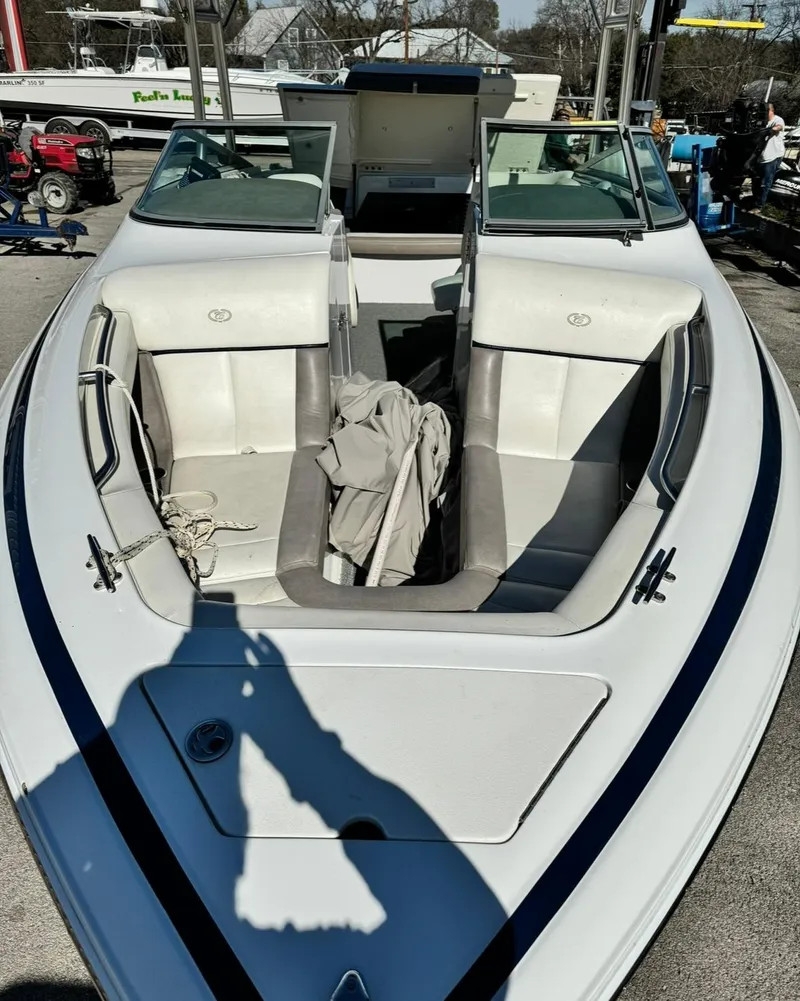 Slide: The Image of 2005 Cobalt GS242 boat with open bow seating, docked outdoors. - 6