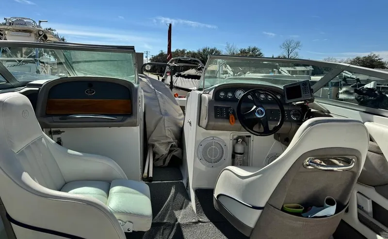 Slide: The Image of Interior of a 2005 Cobalt GS242 boat with white seating and dashboard controls. - 7
