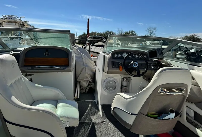 Slide: The Image of Interior of a 2005 Cobalt GS242 boat with steering wheel and seating. - 9