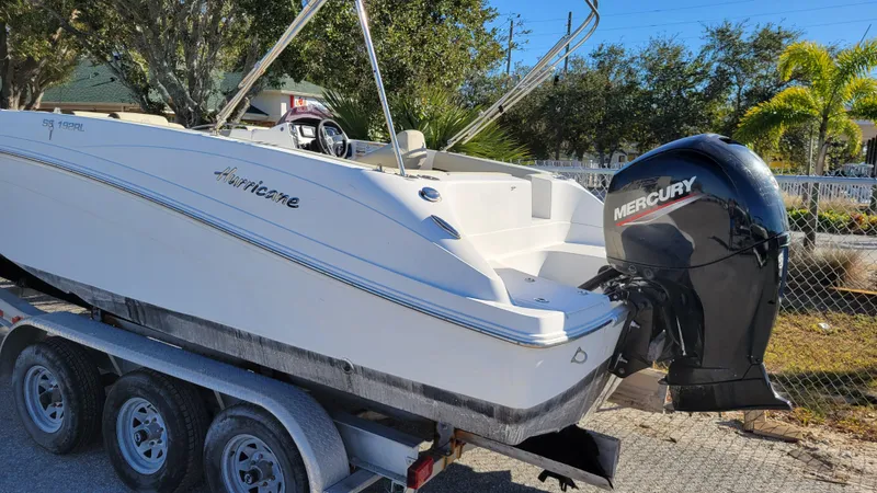 Slide: The Image of 2020 Hurricane SS 192RL PROJECT boat with Mercury outboard motor on a trailer. - 1