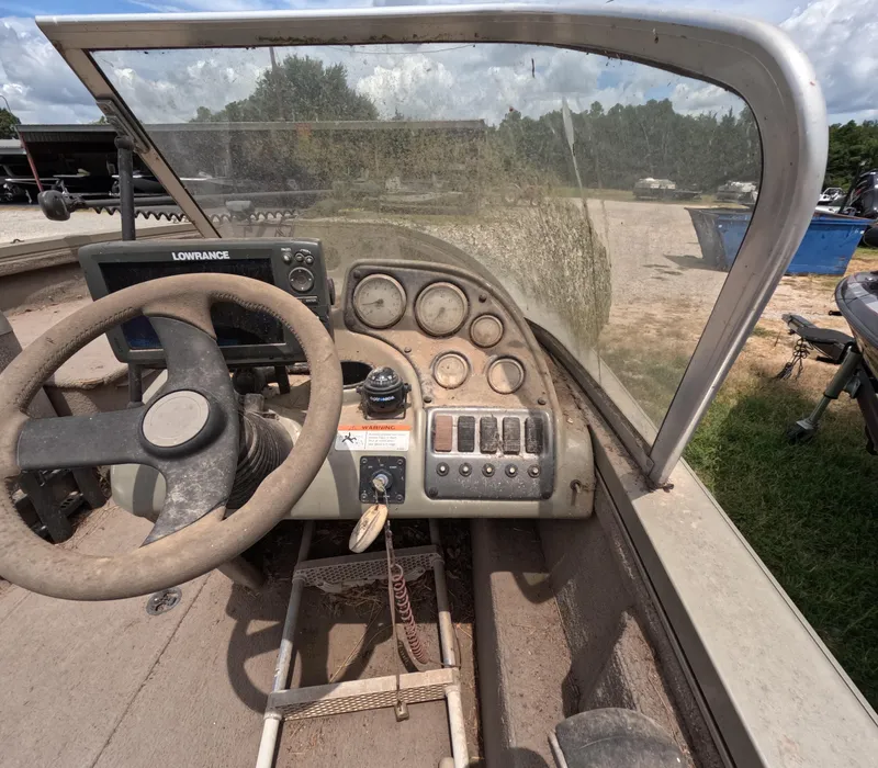 Slide: The Image of 2005 Lowe Fish & Ski FS175 boat dashboard with steering wheel and control panel. - 12