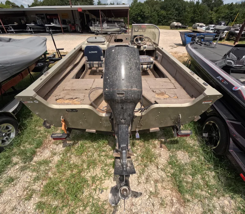 Slide: The Image of 2005 Lowe Fish & Ski FS175 boat with outboard motor, parked on grass. - 17