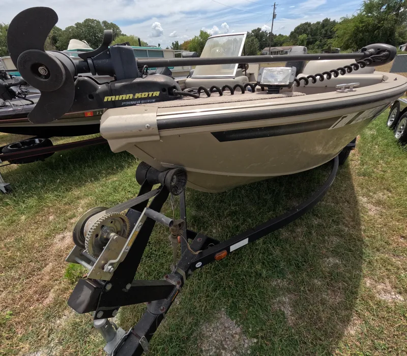 Slide: The Image of 2005 Lowe Fish & Ski FS175 boat on trailer with trolling motor, parked on grass. - 8