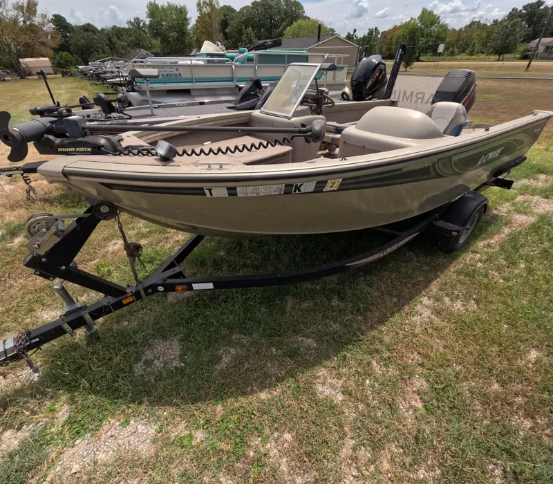 Slide: The Image of 2005 Lowe Fish & Ski FS175 boat on trailer, parked on grass. - 9