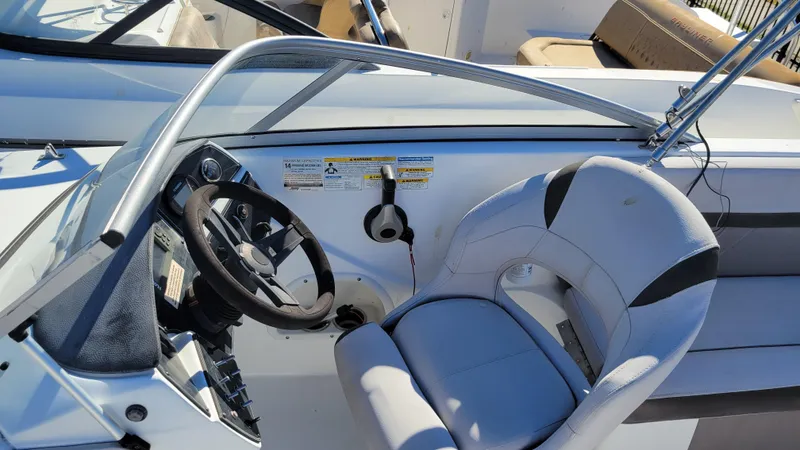 Slide: The Image of 2018 Hurricane SUNDECK 217 PROJECT boat cockpit with steering wheel and seating. - 17