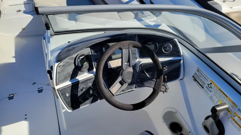 Slide: The Image of 2018 Hurricane SUNDECK 217 PROJECT boat dashboard with steering wheel and controls. - 18