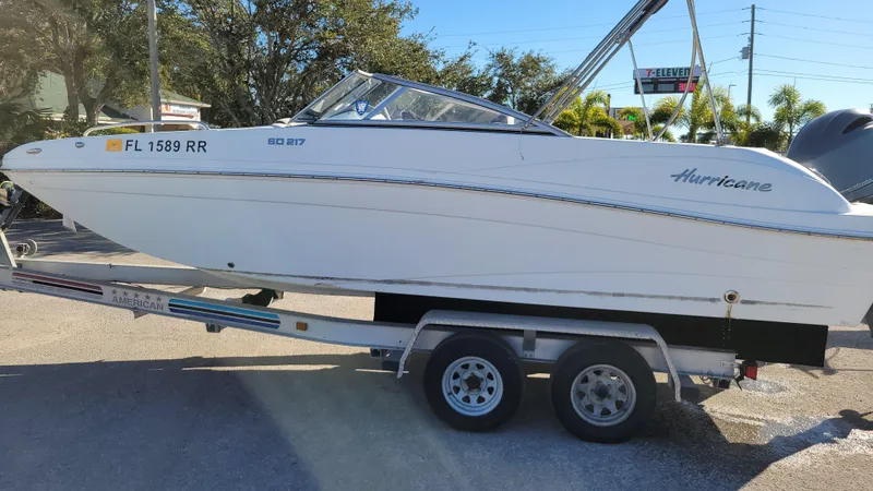 Slide: The Image of 2018 Hurricane SUNDECK 217 boat on trailer in sunny outdoor setting. - 6