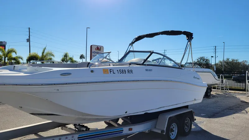 Slide: The Image of 2018 Hurricane SUNDECK 217 PROJECT boat on trailer in sunny outdoor setting. - 7