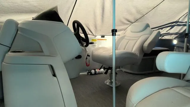Slide: The Image of Interior of 2024 Godfrey Pontoons Sweetwater 2286 SFL, featuring plush seating and steering console. - 4