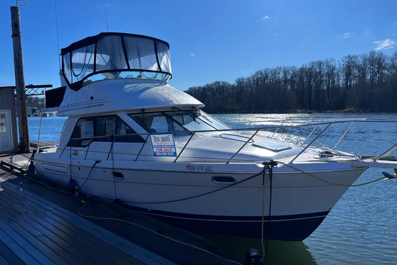 The Image of 1996 Bayliner 3388 Command Bridge Motoryacht docked, for sale sign visible. - 0