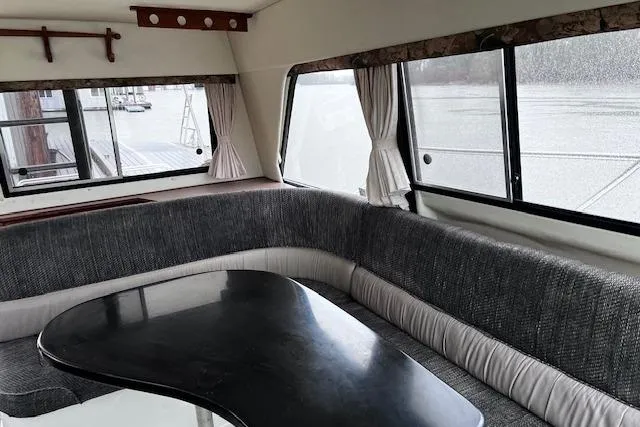 Slide: The Image of Interior of 1996 Bayliner 3388 Command Bridge Motoryacht with gray seating and black table. - 20