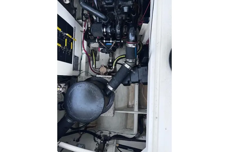 Slide: The Image of Engine compartment of a 1996 Bayliner 3388 Command Bridge Motoryacht, showcasing mechanical components. - 31