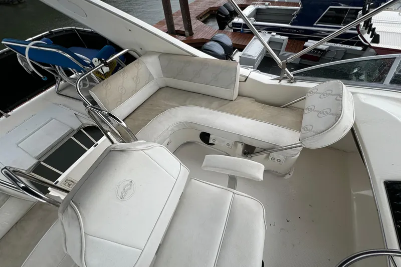Slide: The Image of 1996 Bayliner 3388 Command Bridge Motoryacht interior with white seating and helm. - 37