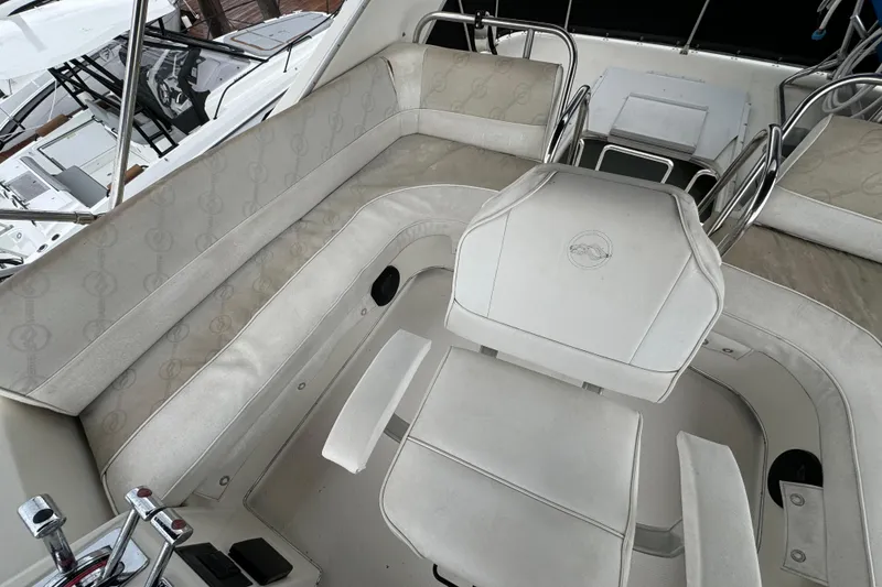 Slide: The Image of 1996 Bayliner 3388 Command Bridge Motoryacht interior with white seating and helm. - 39